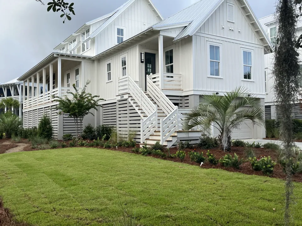 Front lawn and planted beds around a raised home in Kiawah River